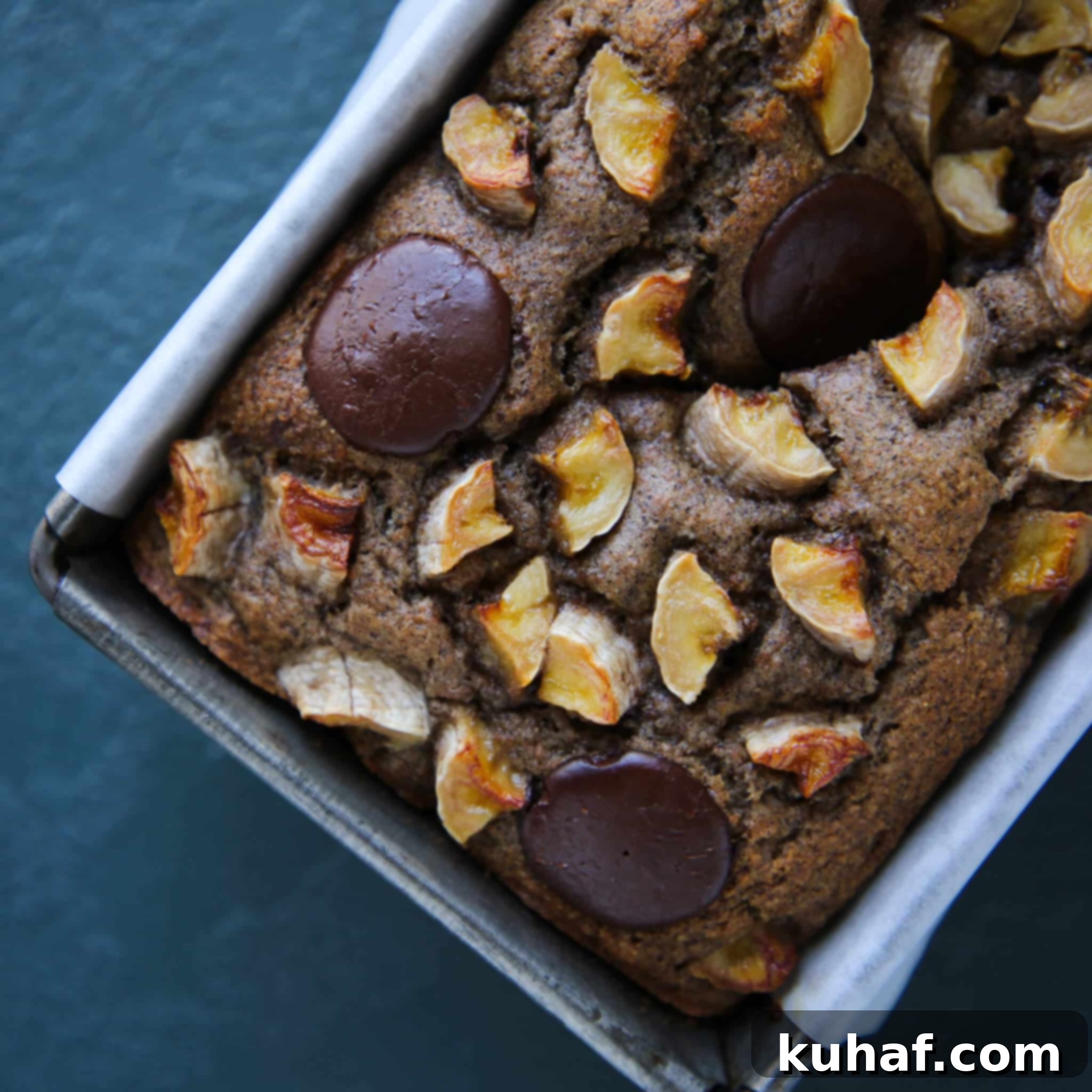 Close-up of the vegan chocolate chip banana bread with a beautiful topping of banana slices and melted chocolate