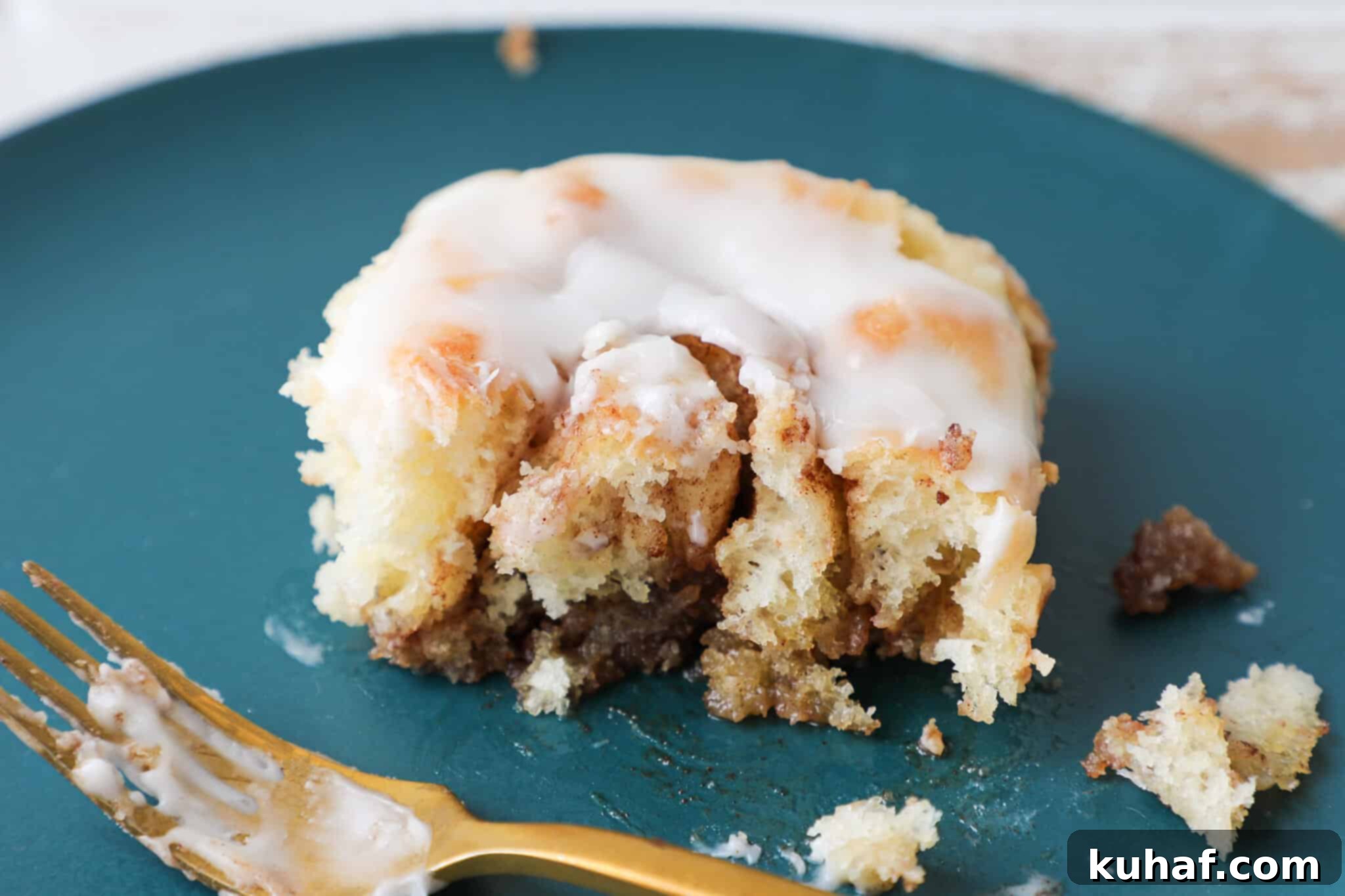 The Best Cinnamon Rolls cut open, revealing the gooey cinnamon filling inside.