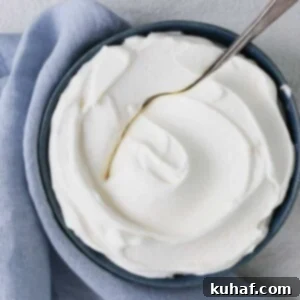 Close-up of fluffy homemade whipped cream, showcasing its texture and ready for serving.