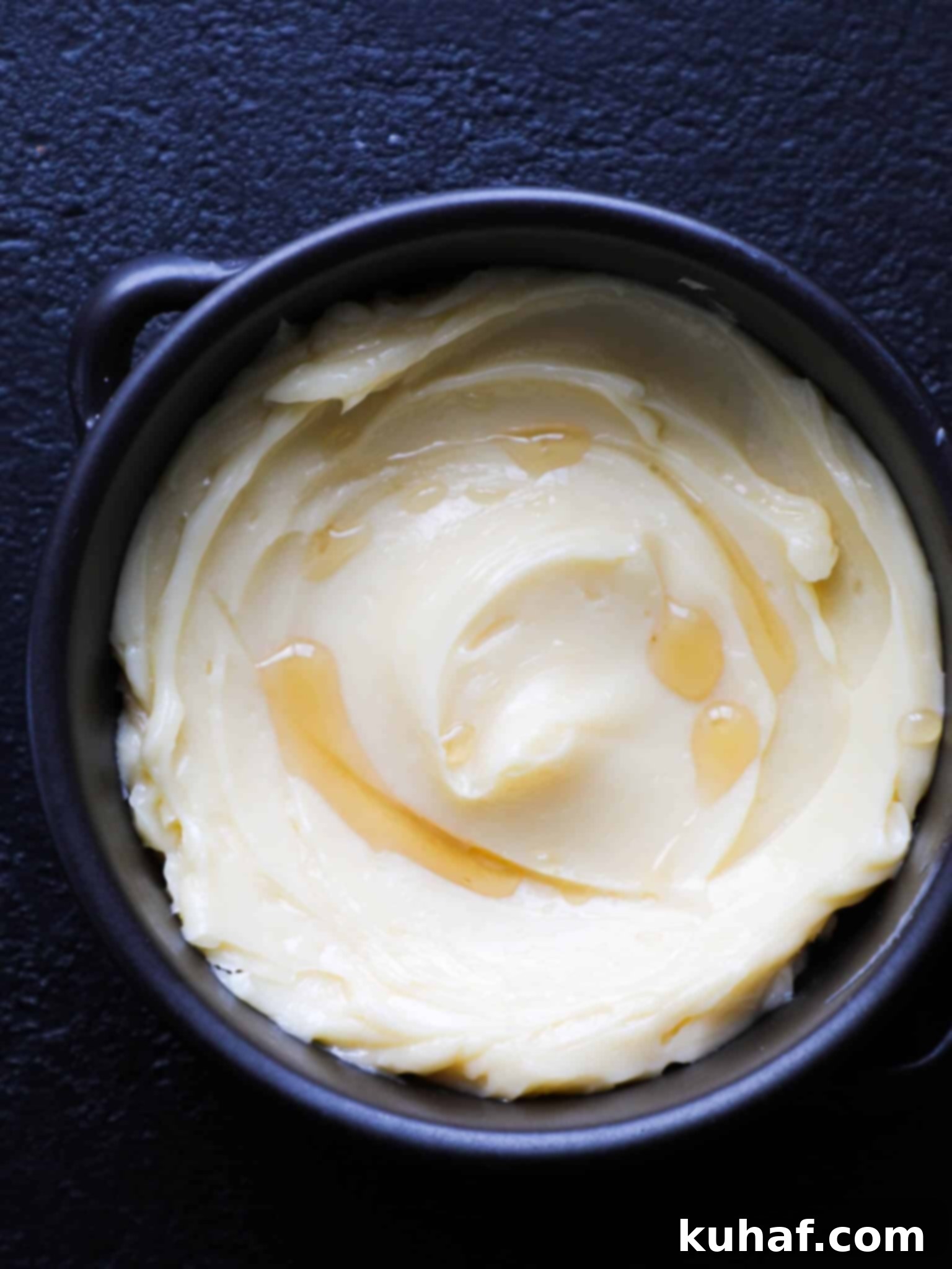 Artisan Maple Butter 2 Homemade Maple Butter in a black bowl, beautifully swirled and ready to be served on various baked goods.