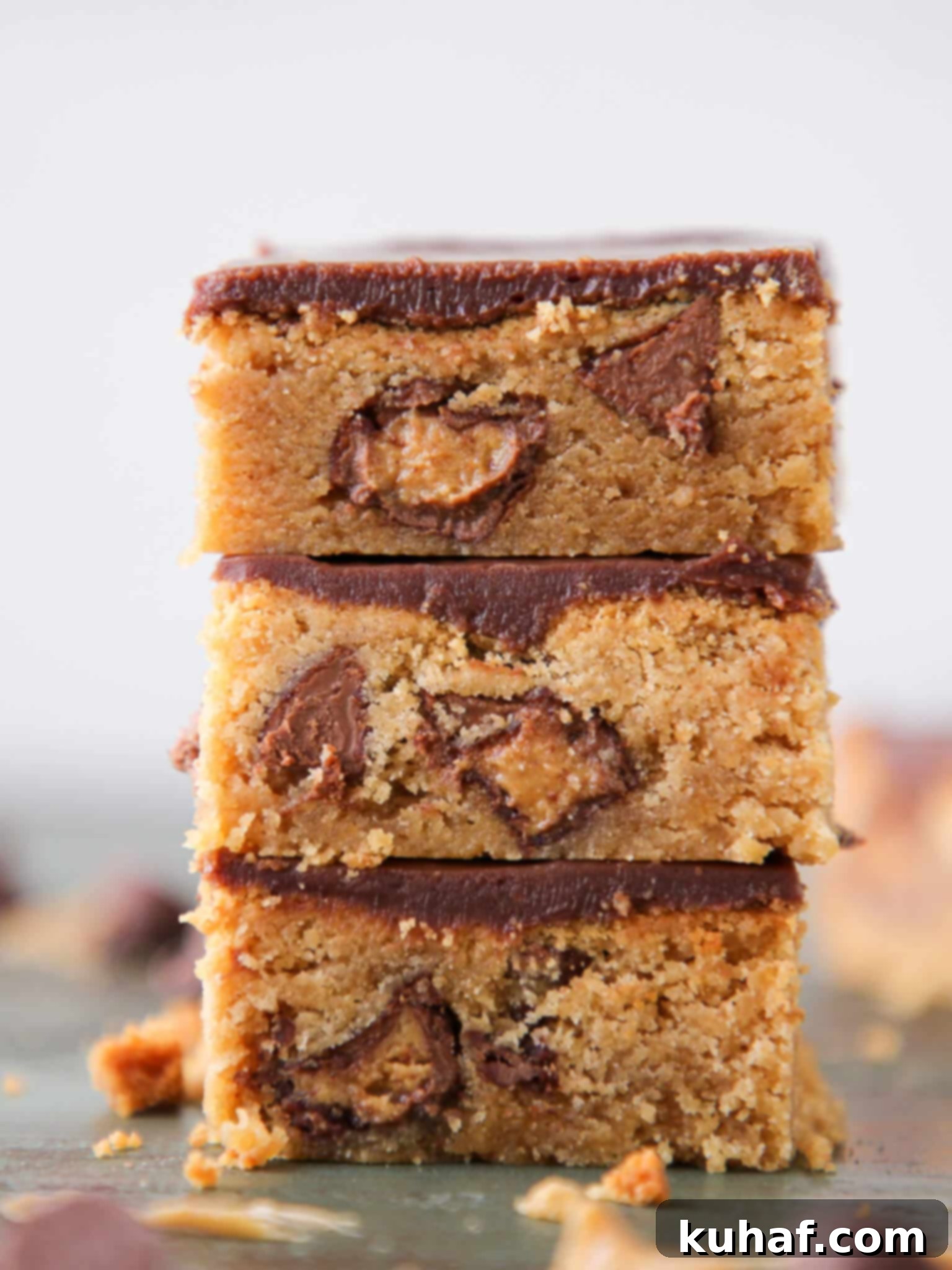 Fudgy Peanut Butter Reeses Chocolate Bars sliced stacked, showcasing their rich texture and ganache topping