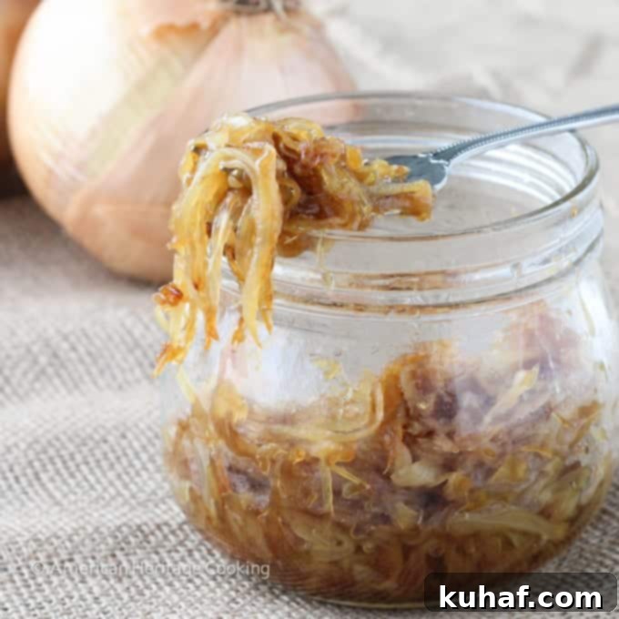 A bowl of finished caramelized onions with a wooden spoon, showcasing their rich color and inviting texture.