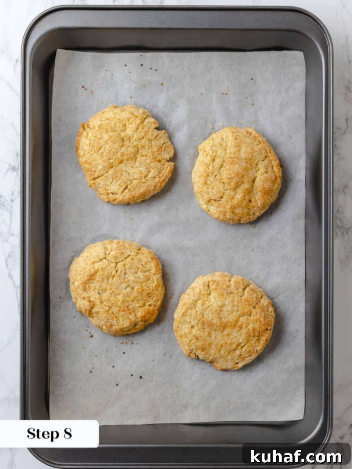 Strawberry Shortcake Solo 12 Baked shortcakes on a parchment-lined sheet, golden brown and crisp, just out of the oven.