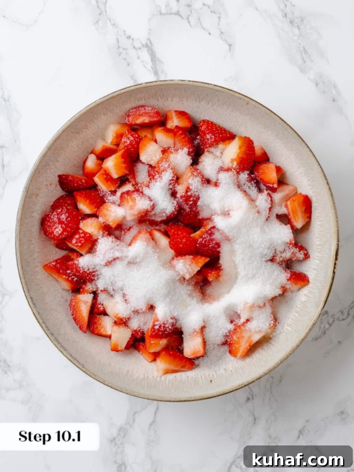 Strawberry Shortcake Solo 13 Freshly cut strawberries coated with sugar and lemon juice in a mixing bowl, ready to macerate.