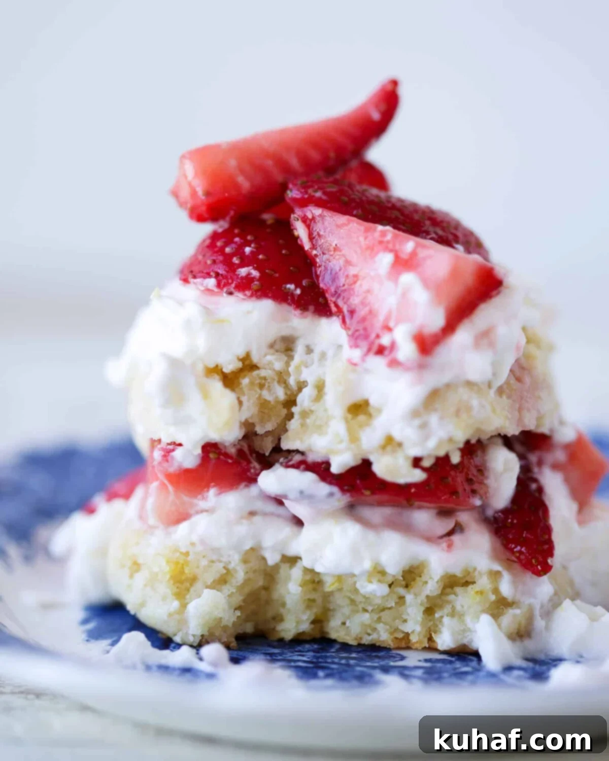 Strawberry Shortcake Solo 3 Strawberry Shortcake for Two cut open, showcasing layers of shortcake, strawberries, and whipped cream, perfect for Valentine's Day Desserts or any special occasion.