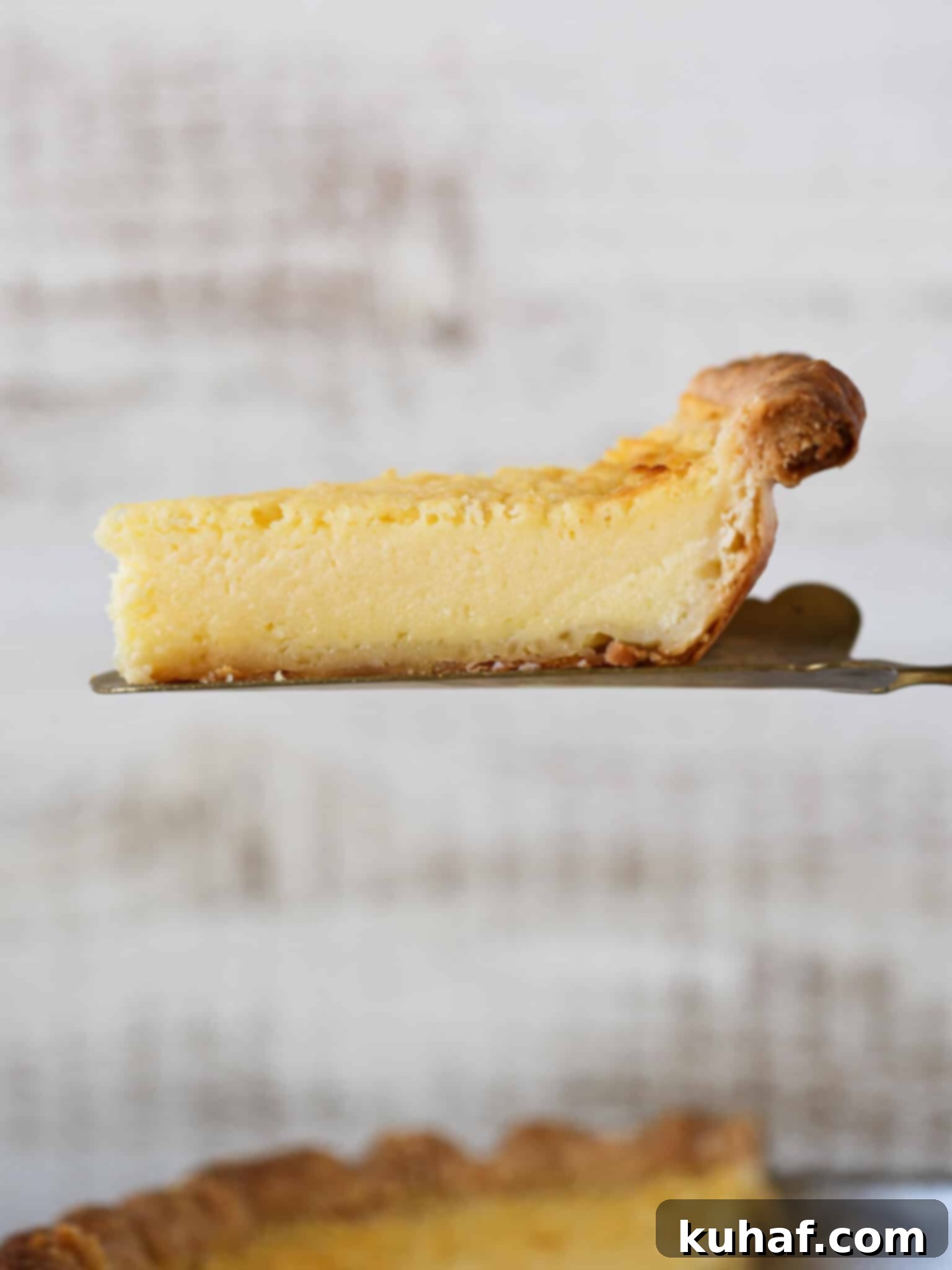 buttermilk pie slice on cake server in air.