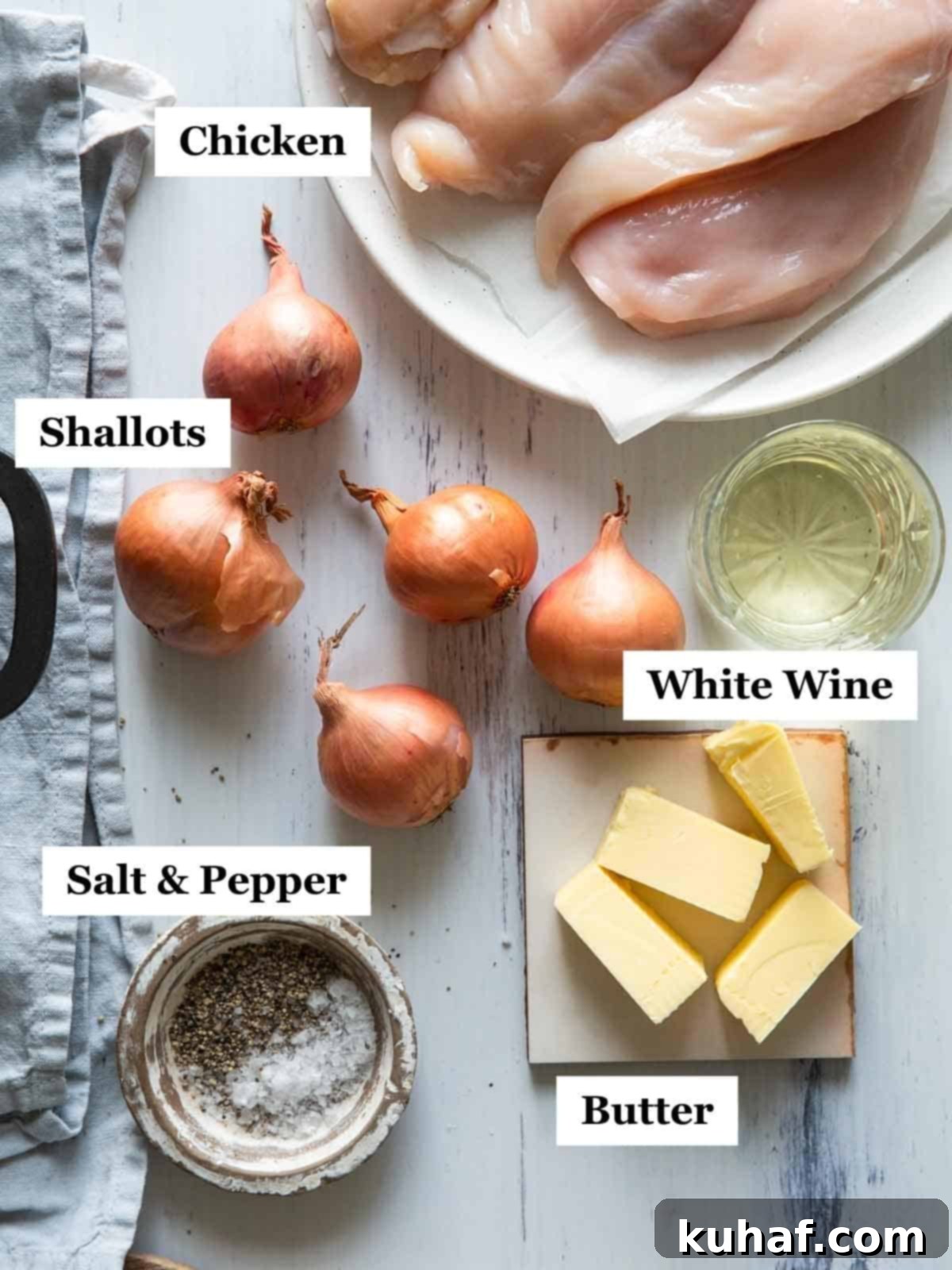 The ingredients of chicken with shallots laid out on a light background.