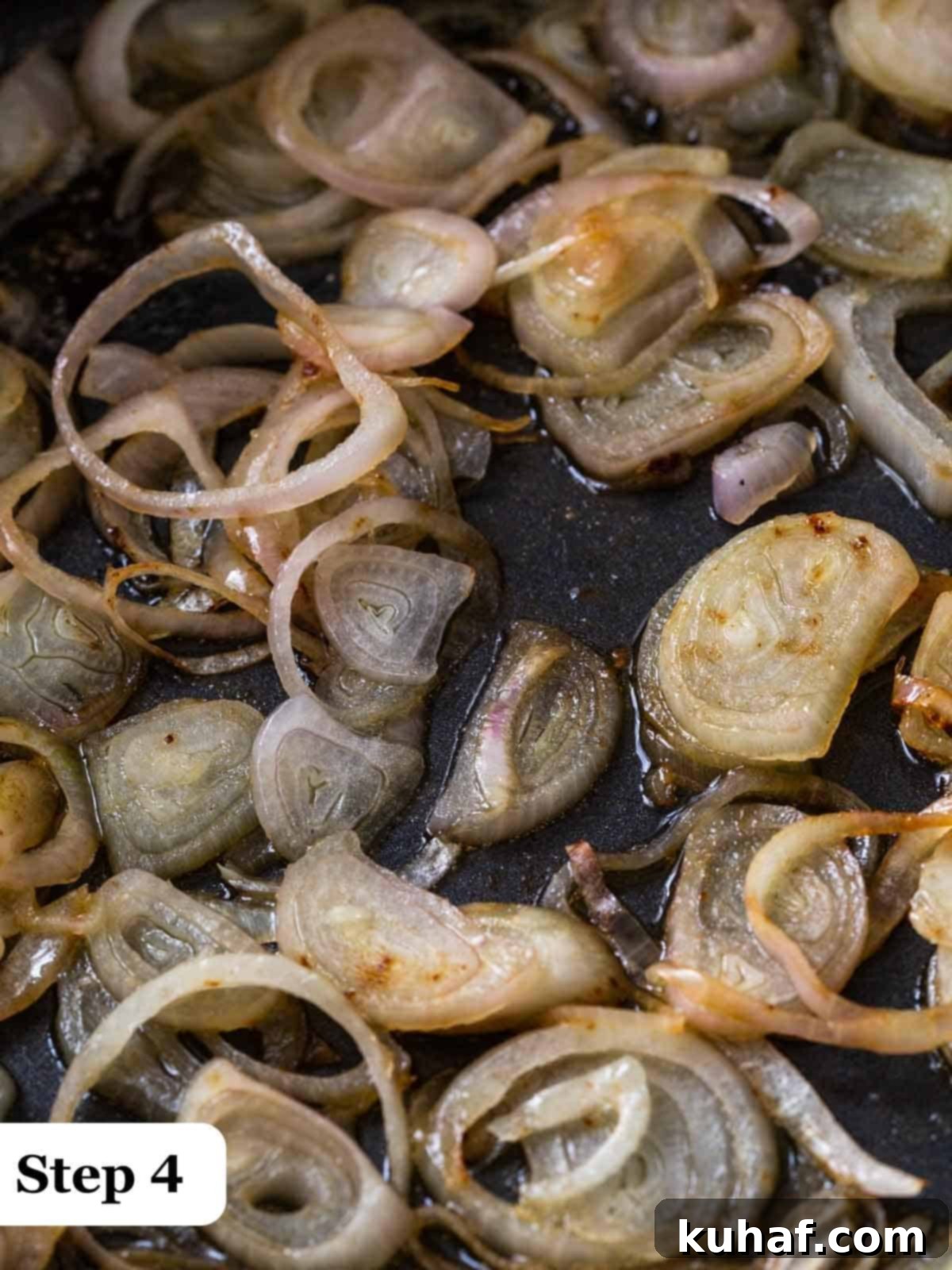 Step 4 of the process, shallots in a cast iron pan being cooked.