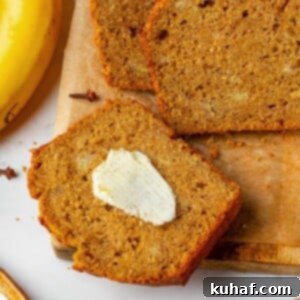 Slice of pumpkin banana bread spread with melting butter on warm crumb - a healthier pumpkin recipe.