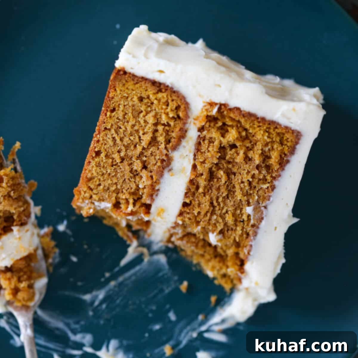 Pumpkin Spice Layer Cake slice bite on fork - a stunning and delicious pumpkin dessert.