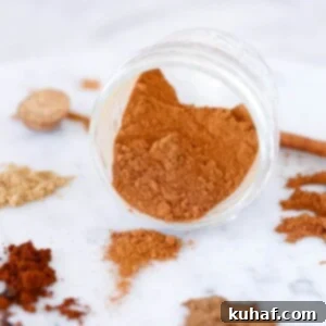 Pumpkin Pie Spice Mix spilling from jar, ready for delicious pumpkin recipes.