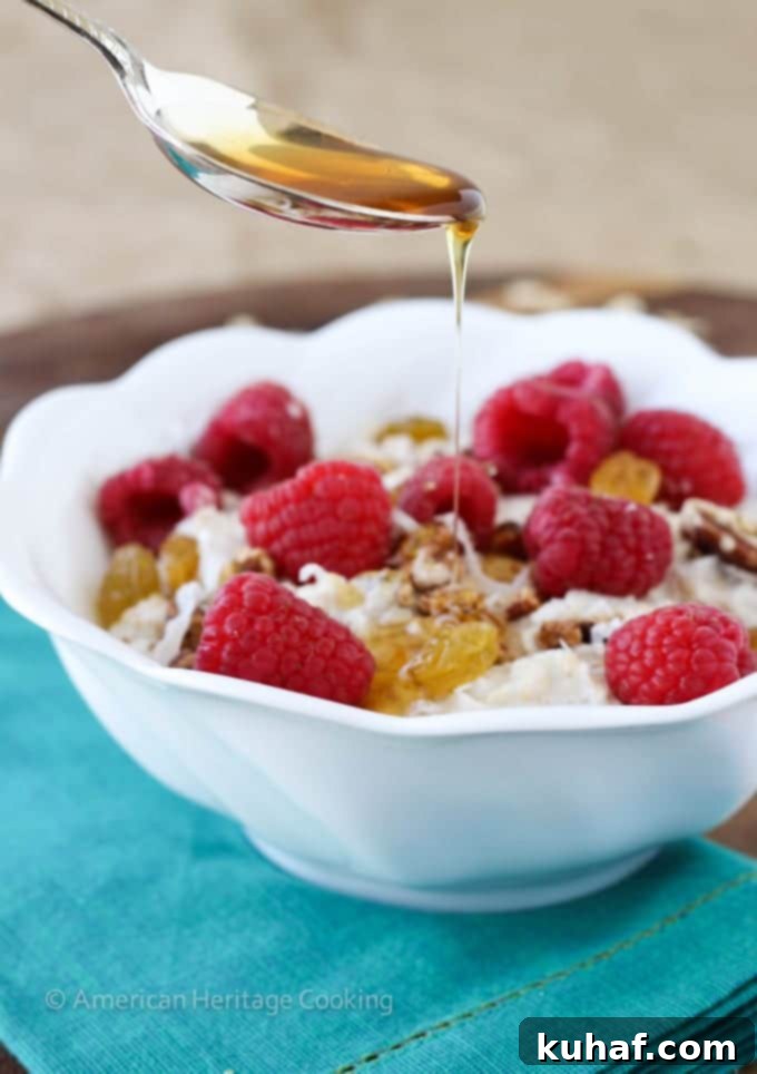 Close-up of creamy Bircher Muesli with a spoon, highlighting its smooth texture.