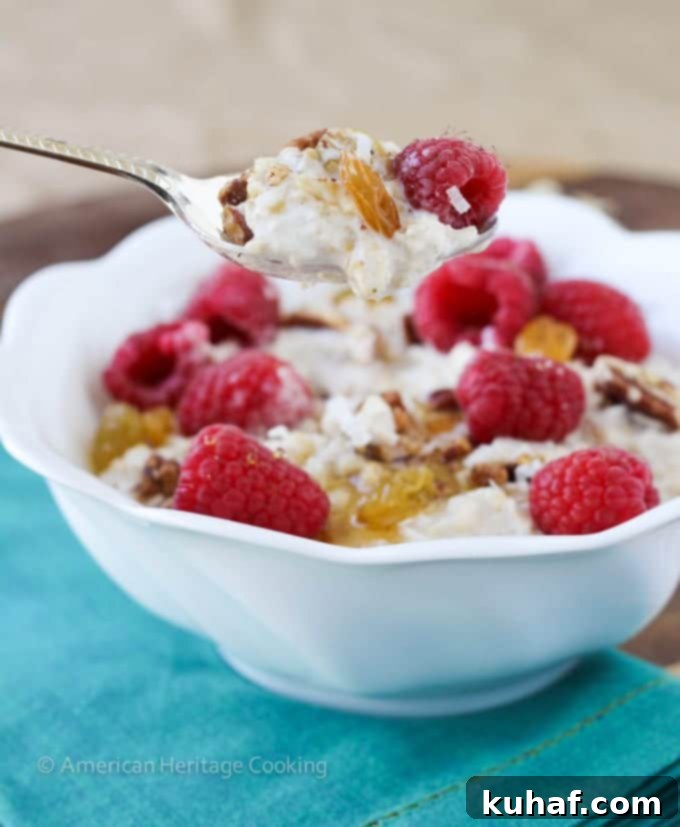 A vibrant bowl of Bircher Muesli topped with fresh berries, coconut flakes, and pecans.
