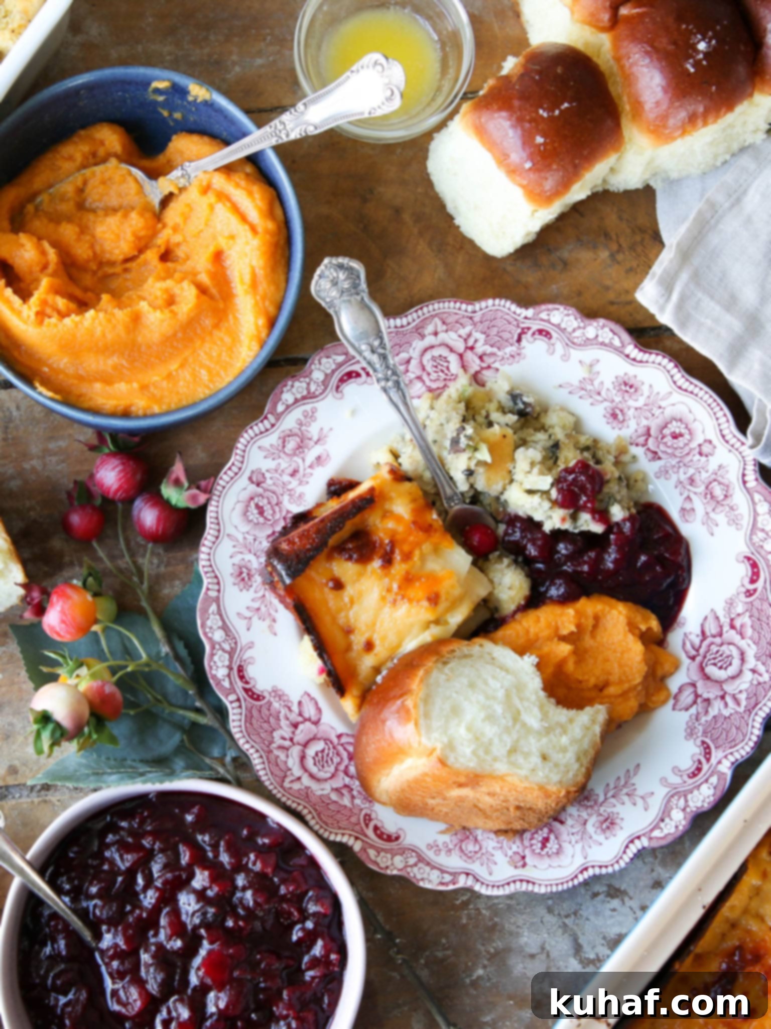 Thanksgiving side dishes plated on elegant pink plates, ready for a festive meal.
