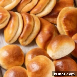 A large group of golden Parker House Rolls, fresh from the oven.