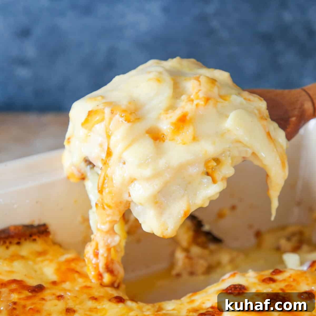 Rich Scalloped Potatoes served on a rustic wooden server.