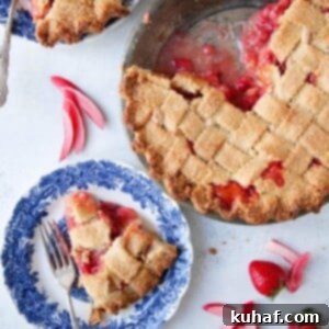 A stunning Strawberry Rhubarb Pie baked in an elegant almond lattice crust, featured prominently for its visual appeal and delicious promise.