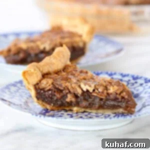 A golden-brown Bourbon pecan pie, featuring a perfectly set, glistening filling and an inviting, crisp crust.