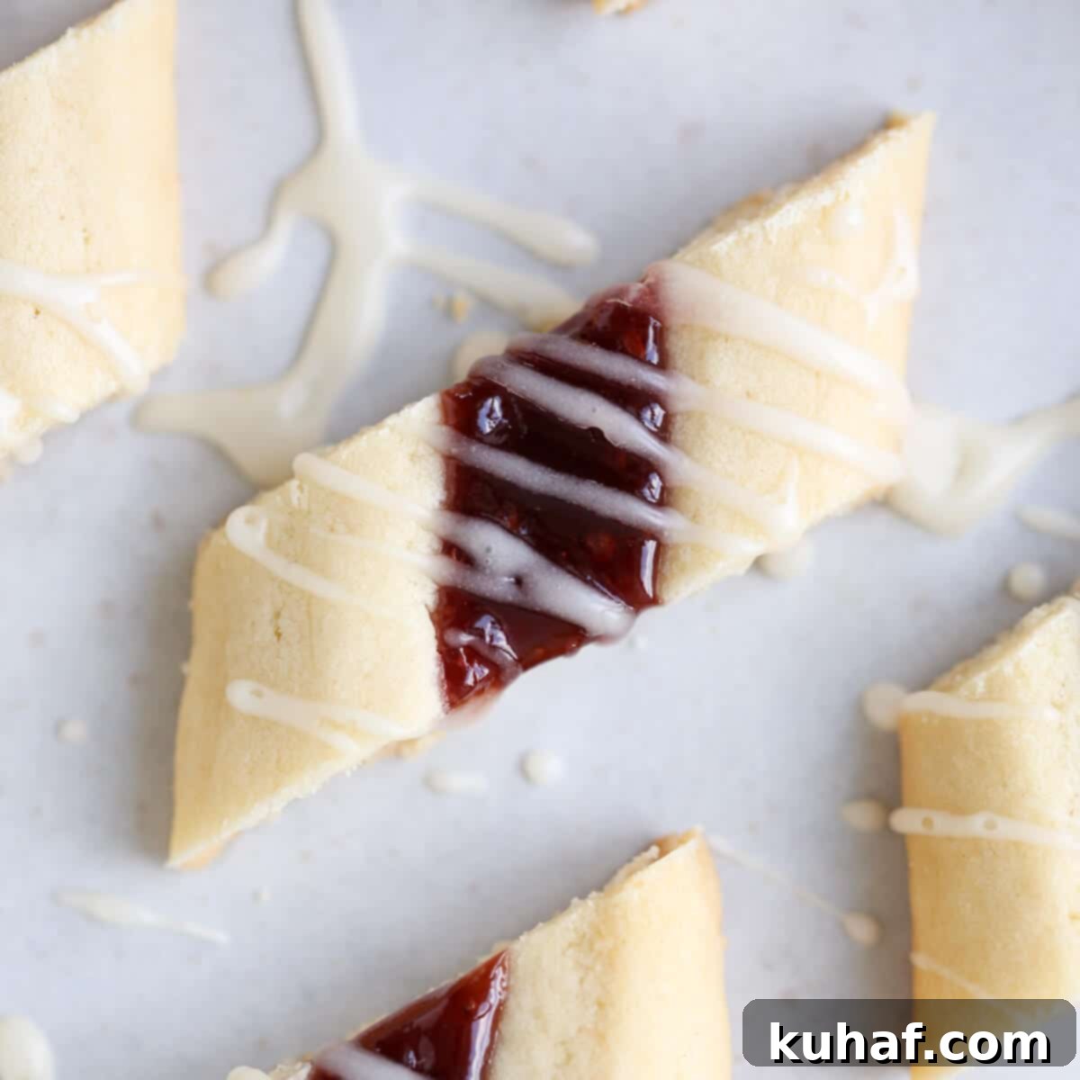 Elegant Raspberry Ribbon Cookies 3 Danish Raspberry Ribbon Cookies Decorated - A close-up of a single cookie showing the jam filling and glaze.