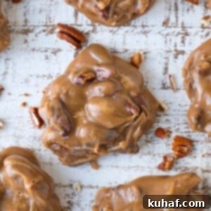 A decadent brown pecan praline with on a brown slate board amid a group.