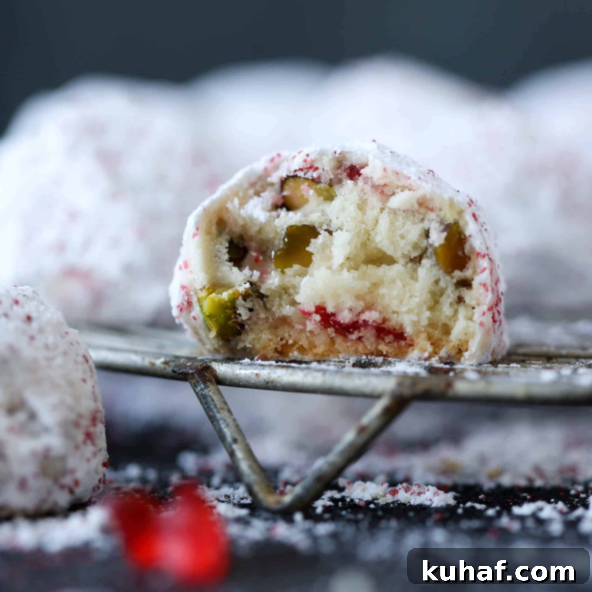 Cherry Pistachio Snowball Cookies Interior: A close-up showing the cross-section of a snowball cookie revealing pistachios and cherries.
