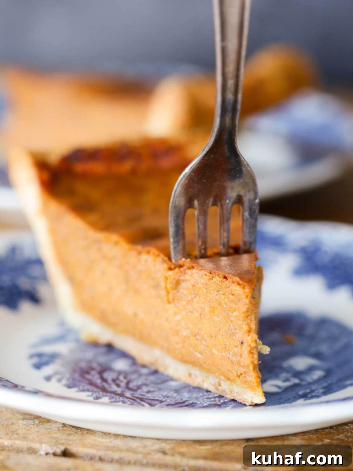 pumpkin pie slice with fork in it.