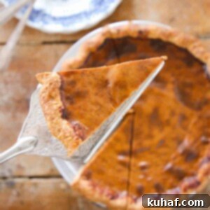 Pumpkin Pie slice on silver pie server.