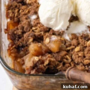 baked apple crisp being dished.