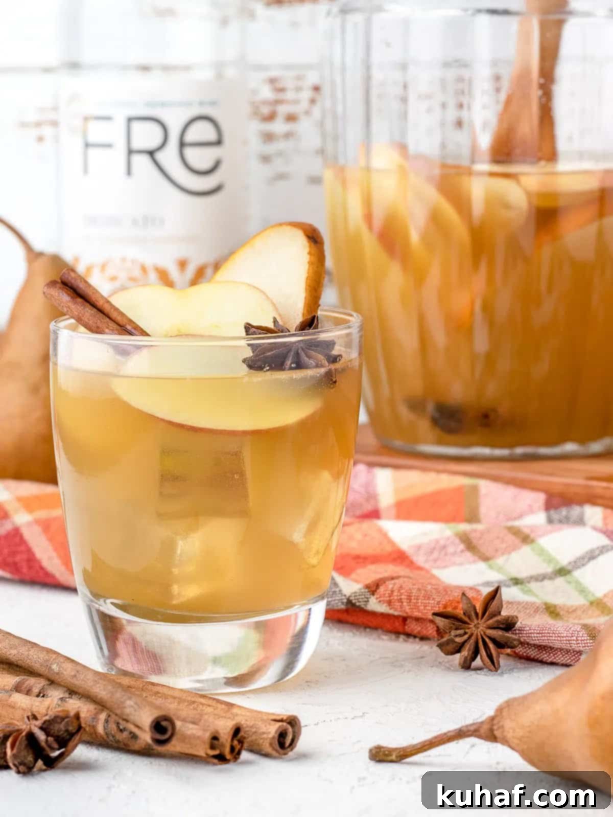 apple cider mocktail in glass with garnish.