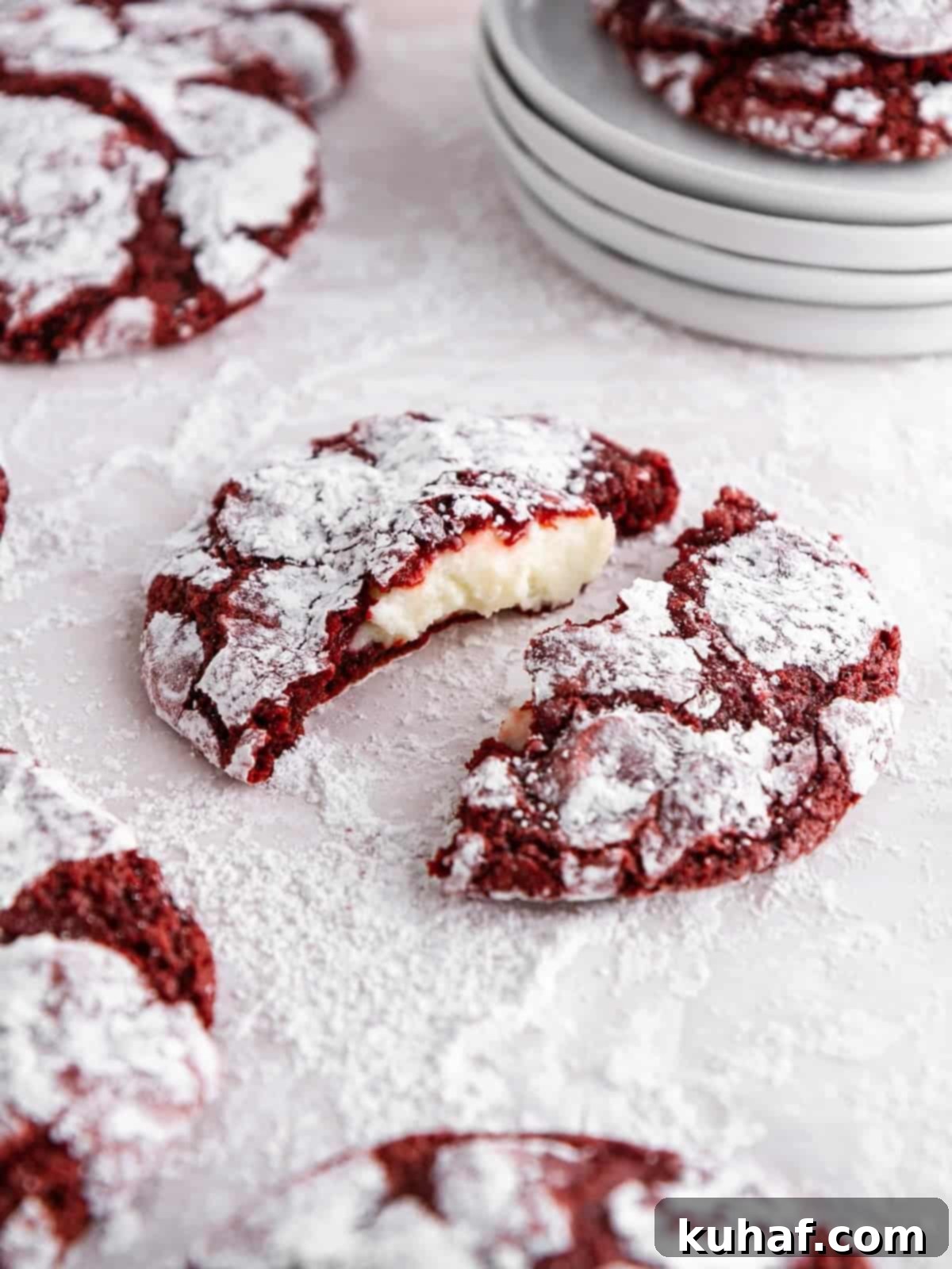 stuffed red velvet crinkle cookie broken open.