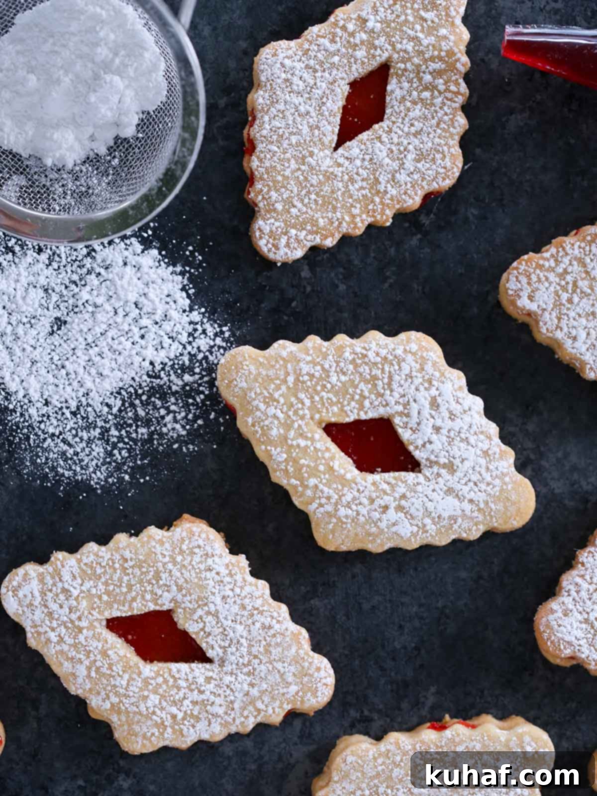 diamond shaped linzers with powdered sugar.