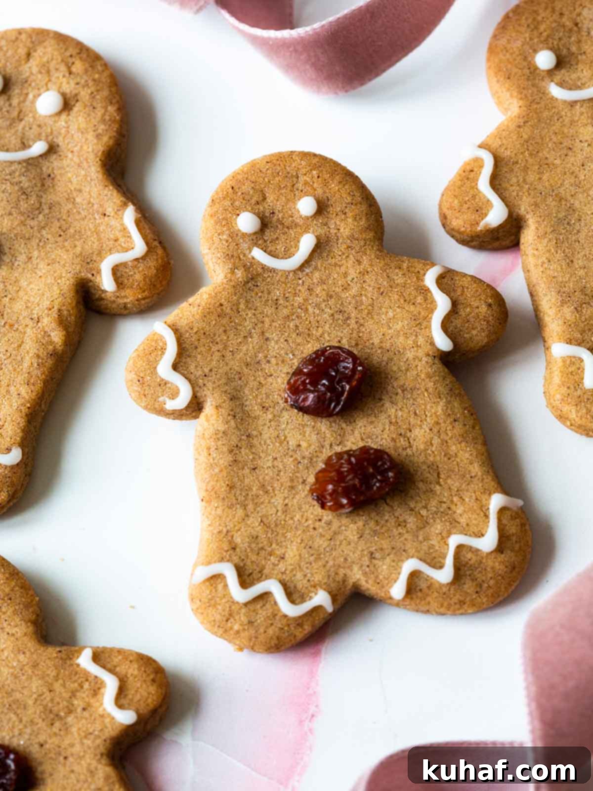 gingerbread cookie with white icing and raisins.