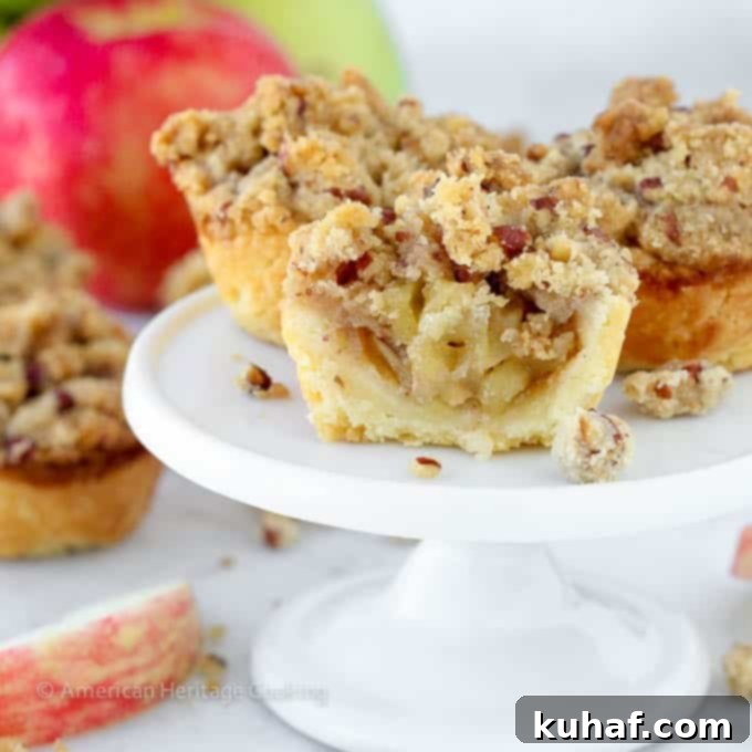 mini apple pies on white cake stand.