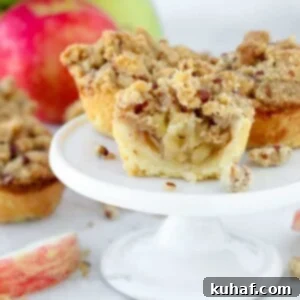 mini apple pies on white cake stand.