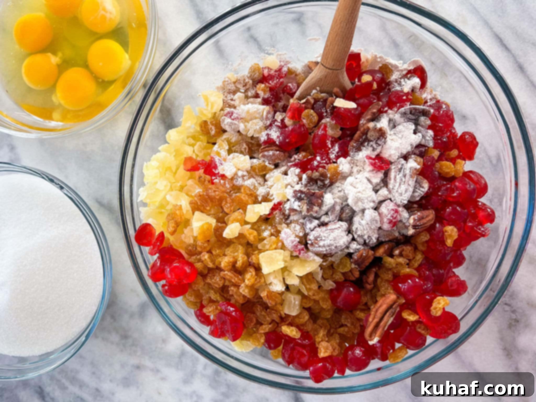 A large mixing bowl filled with various dried fruits and nuts, ready to be incorporated into the fruit cake batter.