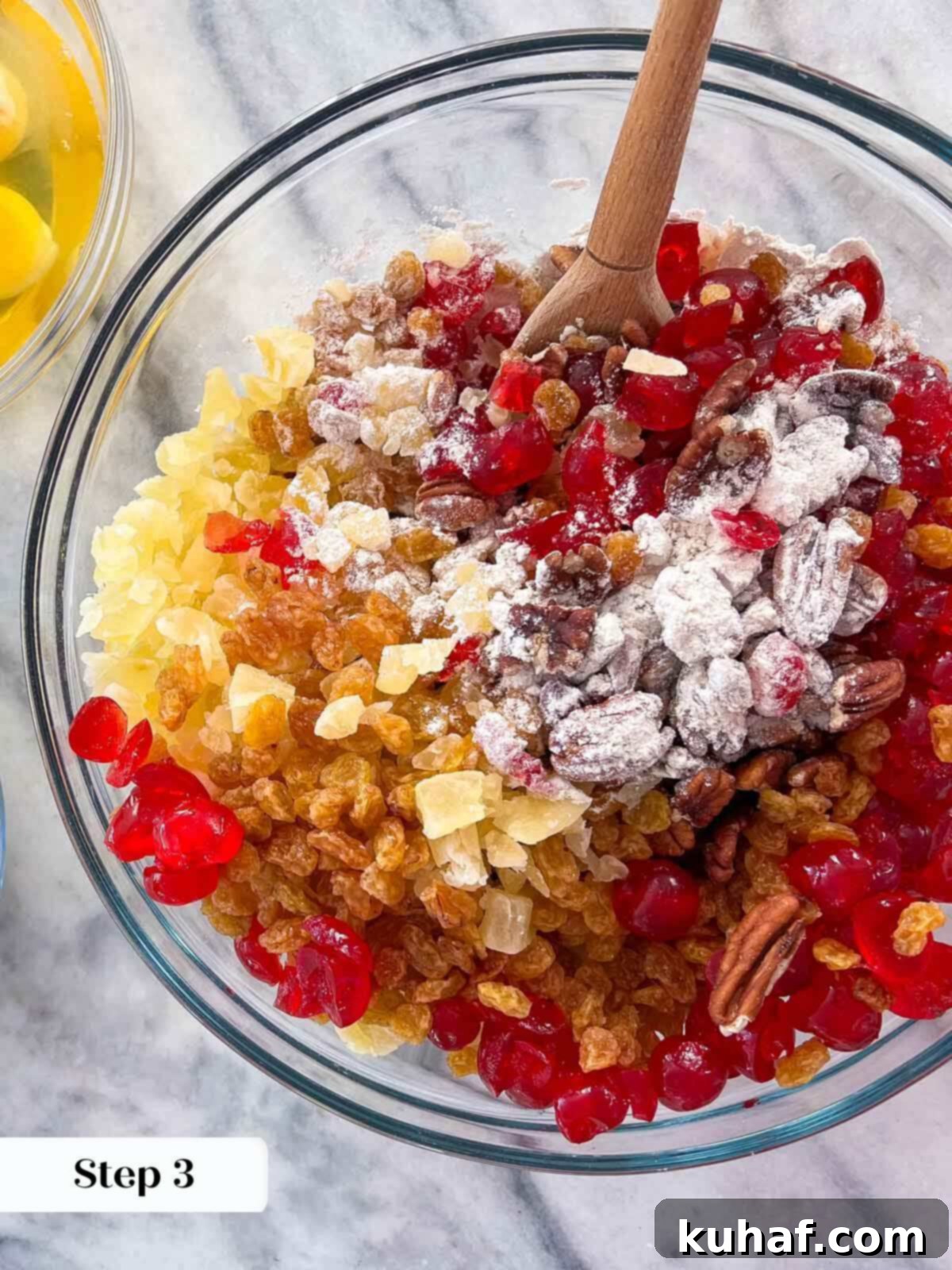 A bowl filled with various chopped dried fruits and nuts, ready for the fruit cake recipe.