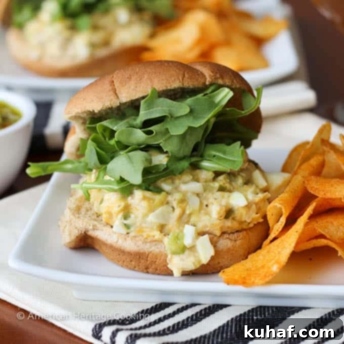 A beautifully presented tuna melt sandwich on a brioche bun, resting on a rustic cloth napkin.
