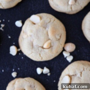 White Chocolate Macadamia Nut Cookies on a dark countertop.