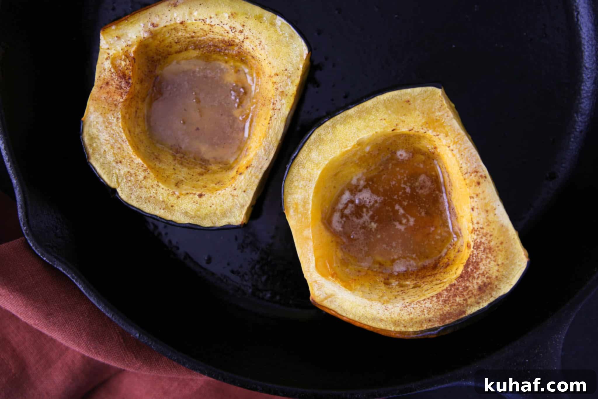 Brown Sugar Baked Acorn Squash Roasted, showcasing the perfectly roasted interior of an acorn squash half, glistening with melted butter and brown sugar.