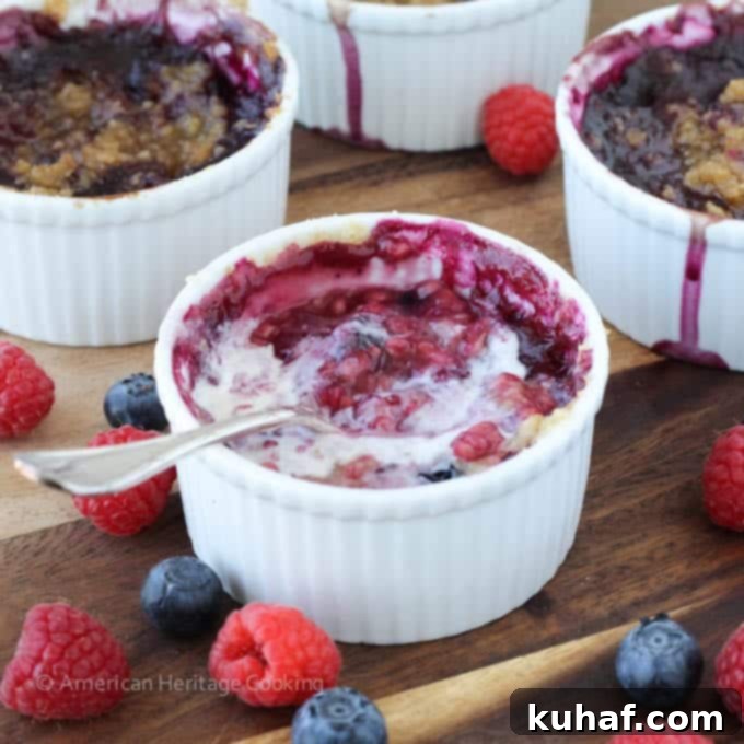 A vibrant individual blueberry raspberry crumble, ready to be served, highlighting the fresh berry colors.