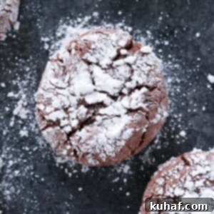 Quick Chocolate Treats 14 Chocolate Crackle Cookie with powdered sugar on black surface Easy Chocolate Desserts.