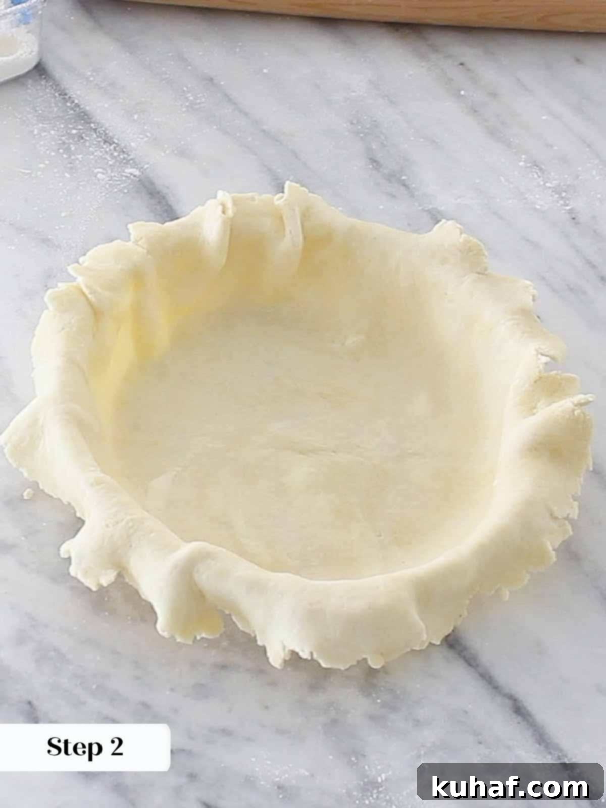 pie dough overhanging sides of pie dish before trimming.