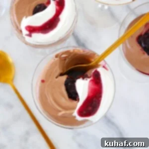 Romantic Valentine's Desserts 11 Chocolate Mousse served in a glass with a gold spoon.