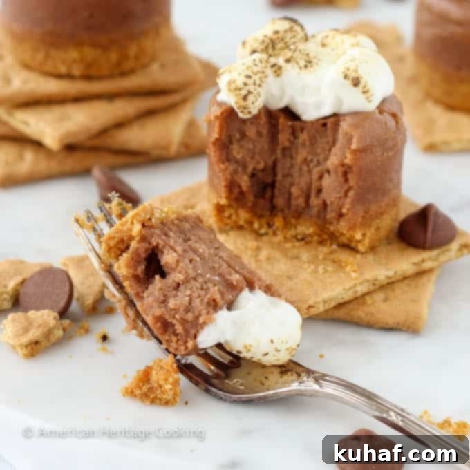 Freshly baked Mini Smores Milk Chocolate Cheesecakes topped with mini marshmallows