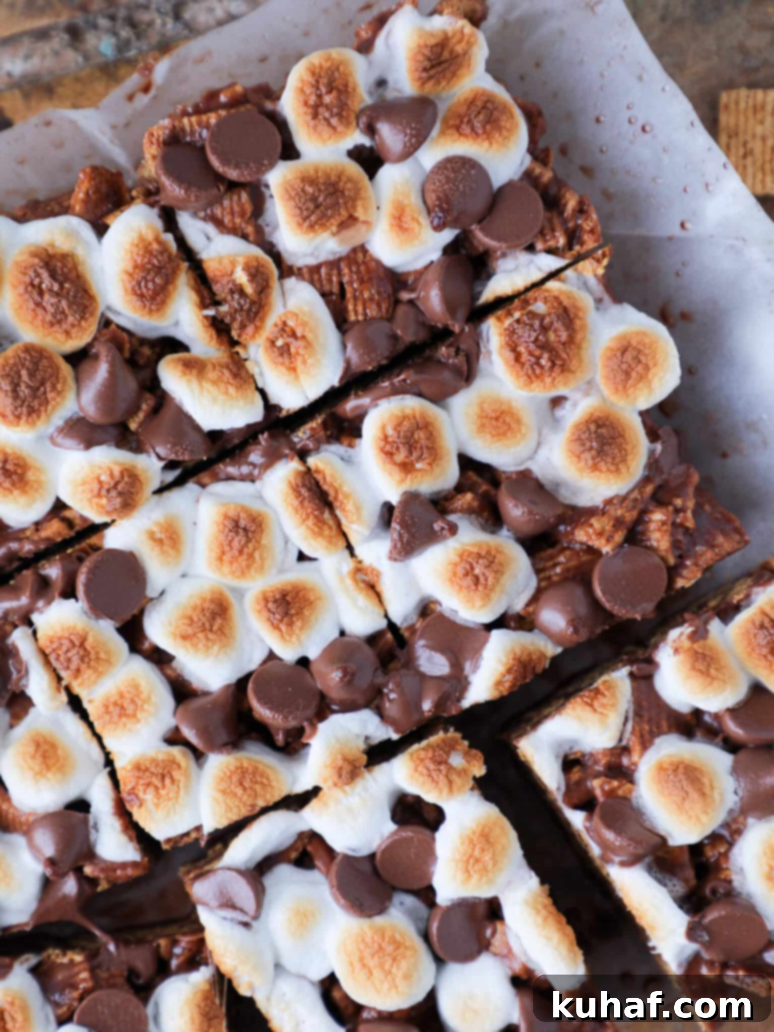 No Bake Golden Graham Smores Bars sliced on parchment paper