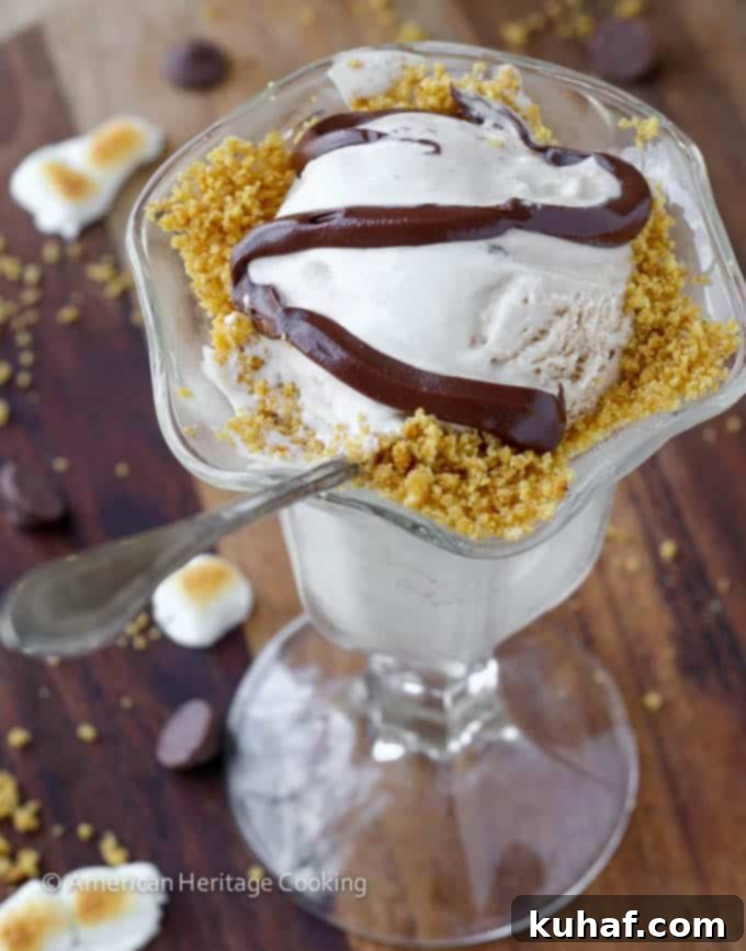 Several scoops of Toasted Marshmallow Smores Ice Cream in a serving dish, garnished with graham cracker sand