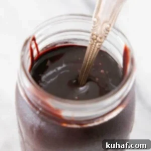 chocolate fudge sauce in jar on marble.