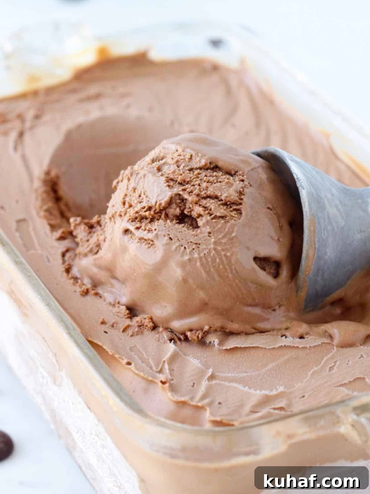 Velvety Homemade Chocolate Ice Cream 2 One scoop of rich, creamy chocolate ice cream in a white bowl, ready to be enjoyed.