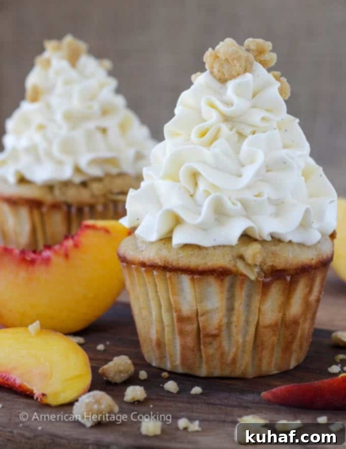 Peach Crisp Cupcakes filled with peach compote and topped with Swiss meringue buttercream