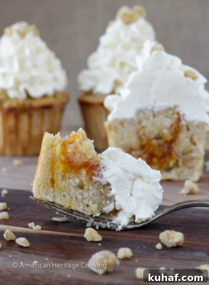 Peach Crisp Cupcakes filled with peach compote and topped with Swiss meringue buttercream